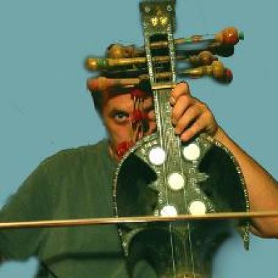 Photo of academic Stuart Hall holding an instrument